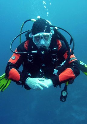 divers-scuba-divers-diving-underwater-37530-37530 A diver in a drysuit exploring the ocean depths with full scuba gear.