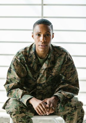 A thoughtful soldier in uniform, representing strength and service.